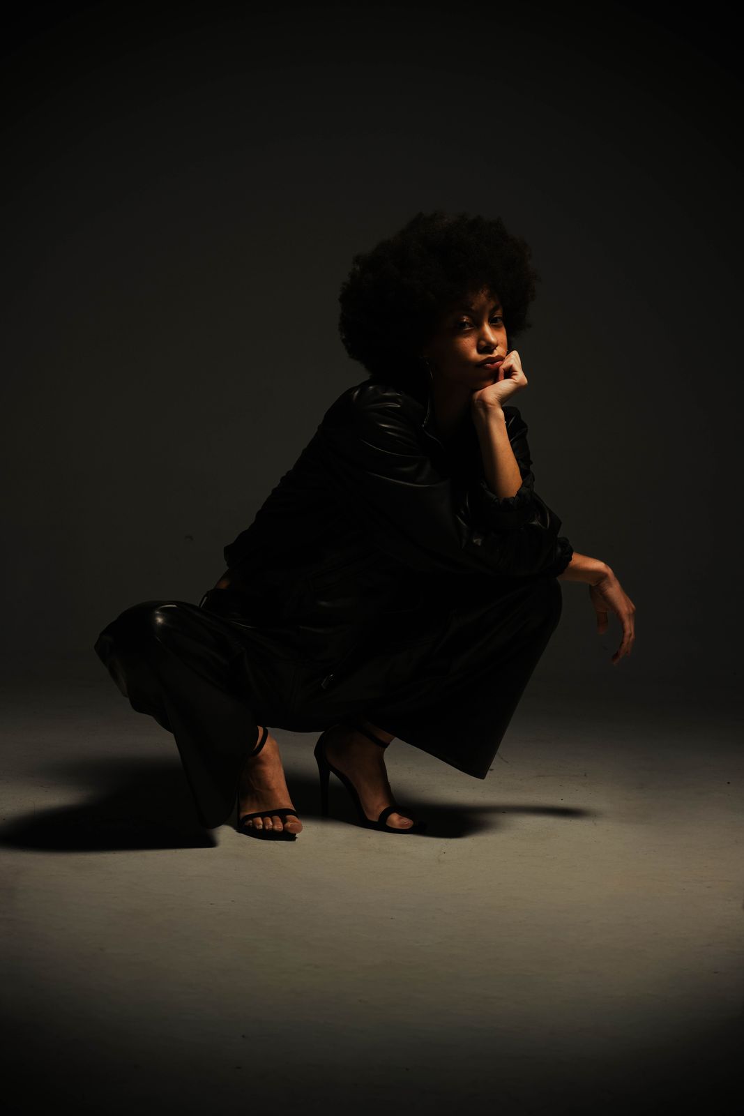 ari LaVon crouched in shadow